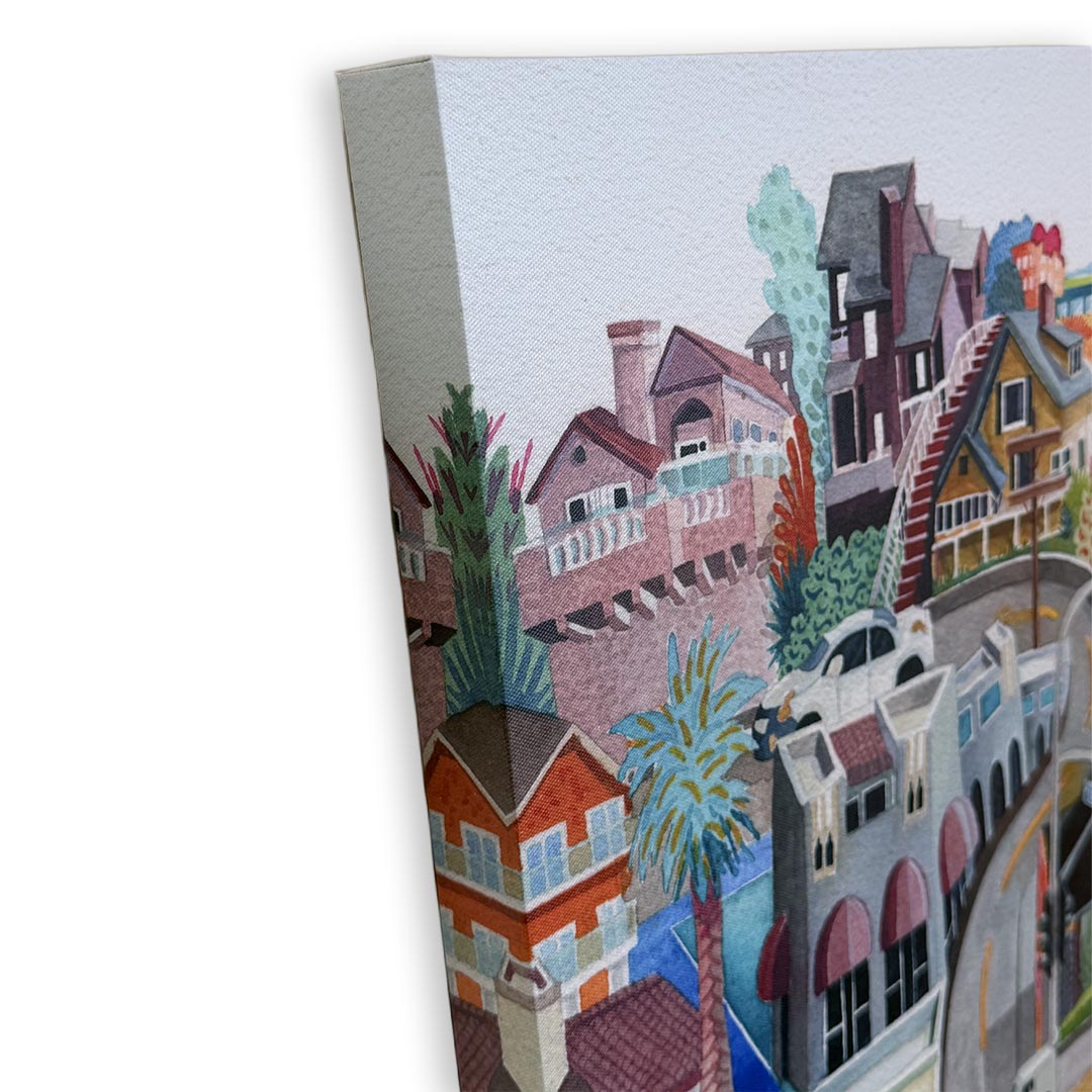 A watercolor-style canvas print showing a colorful coastal town or harbor scene with buildings, palm trees, and boats, photographed at an angle against a white background.