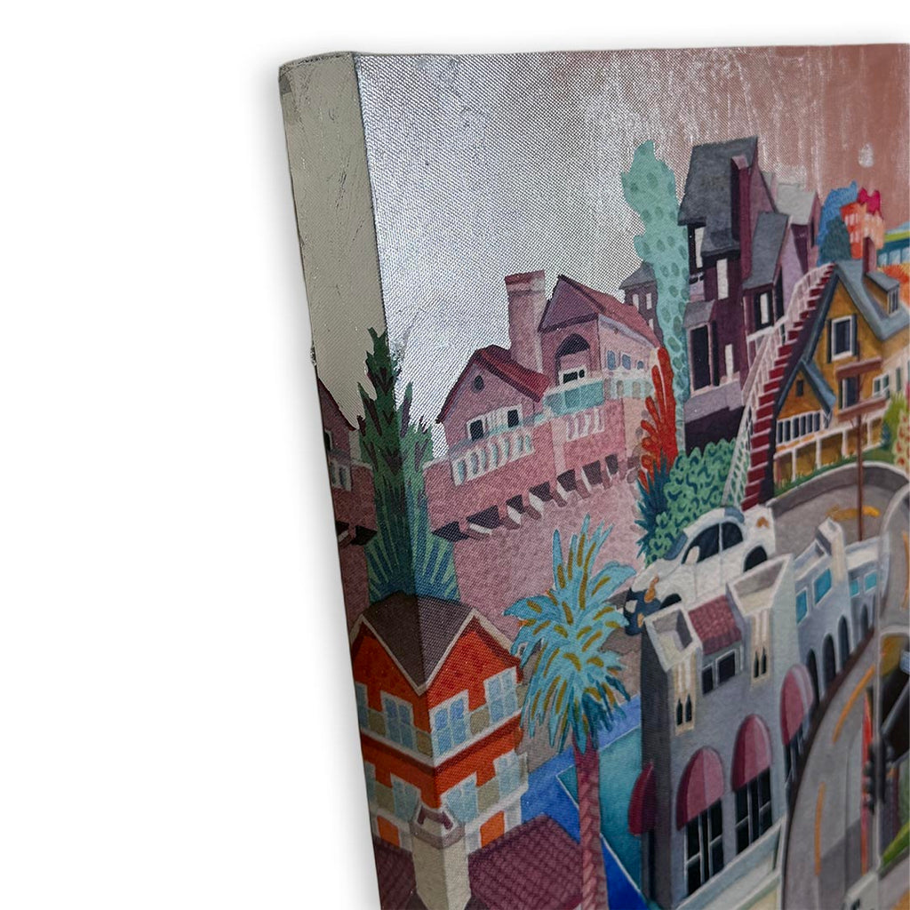 A close-up of a textured canvas painting depicting a colorful coastal town with houses, palm trees, and a car, shown at an angle against a white background. Silver foil sky.