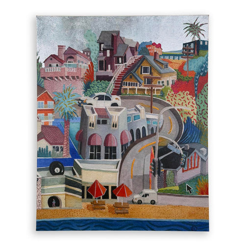A stylized colorful painting of a coastal hillside town with houses, palm trees, a curved road, beach umbrellas, and ocean water at the bottom, shown against a light gray background. Silver foil sky.