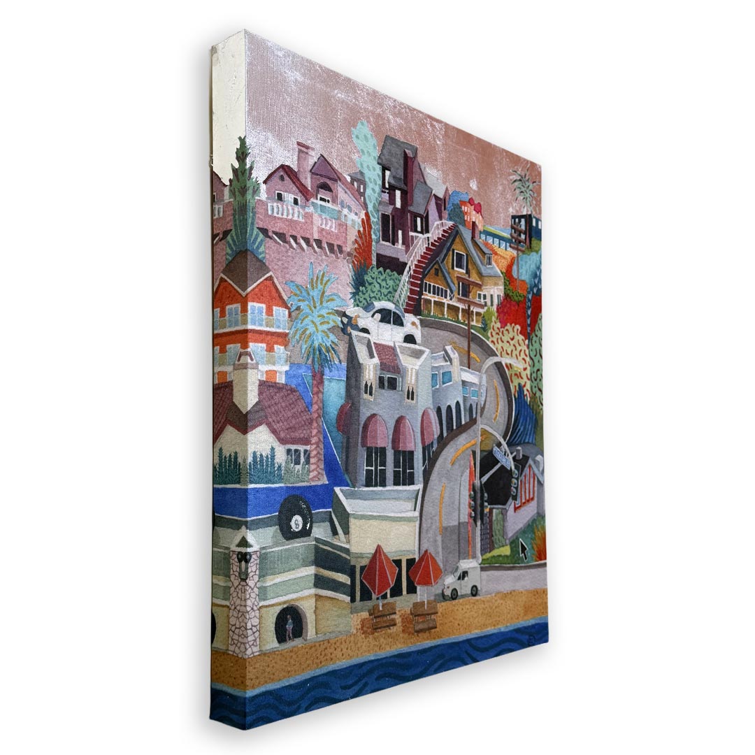 A stylized multicolor canvas wall art print depicting a coastal town with houses, palm trees, a beach, and blue water, shown at an angle against a white background. Silver foil sky.