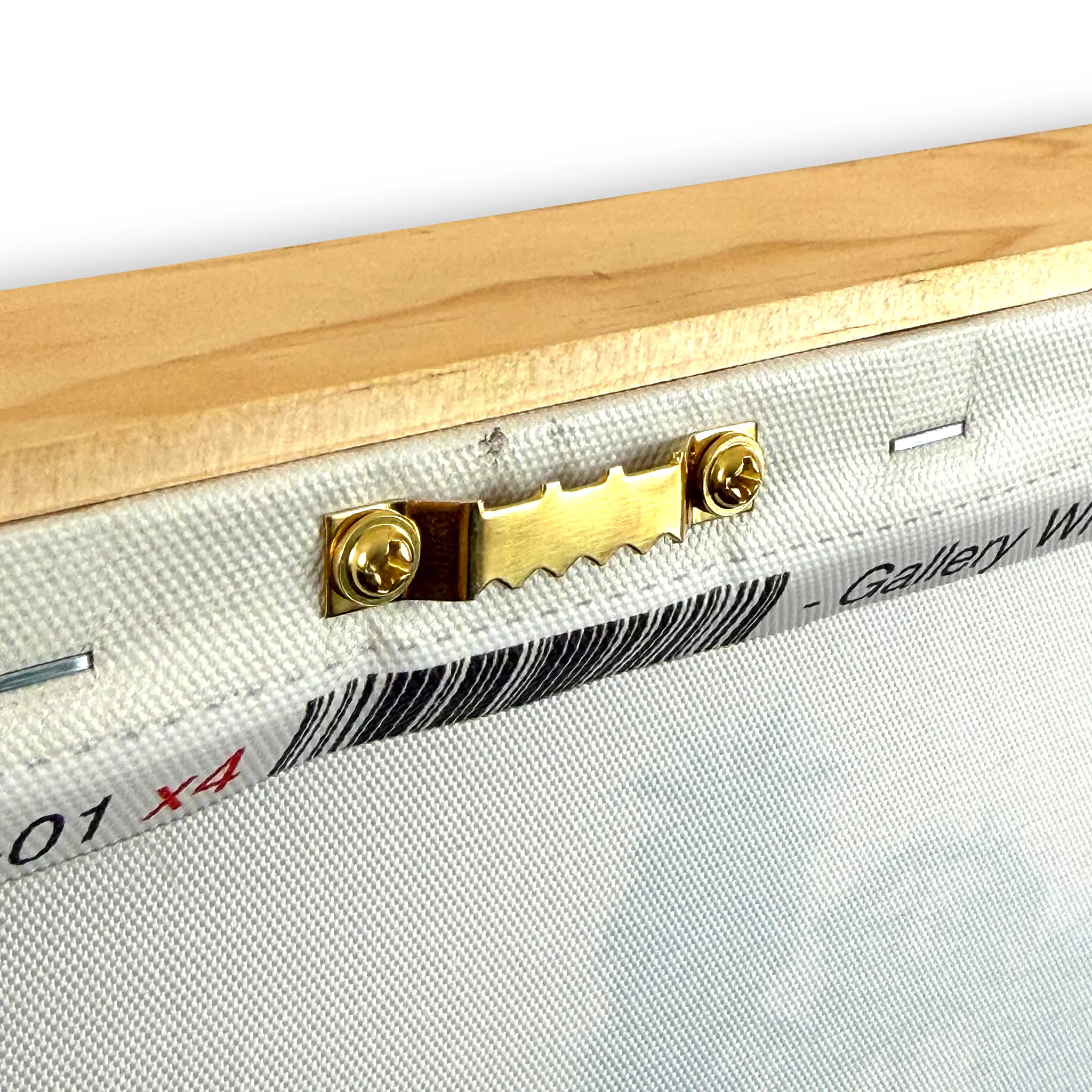 Close-up of the back corner of a canvas print on a wooden frame, showing a brass hanging hardware piece attached to the canvas edge.