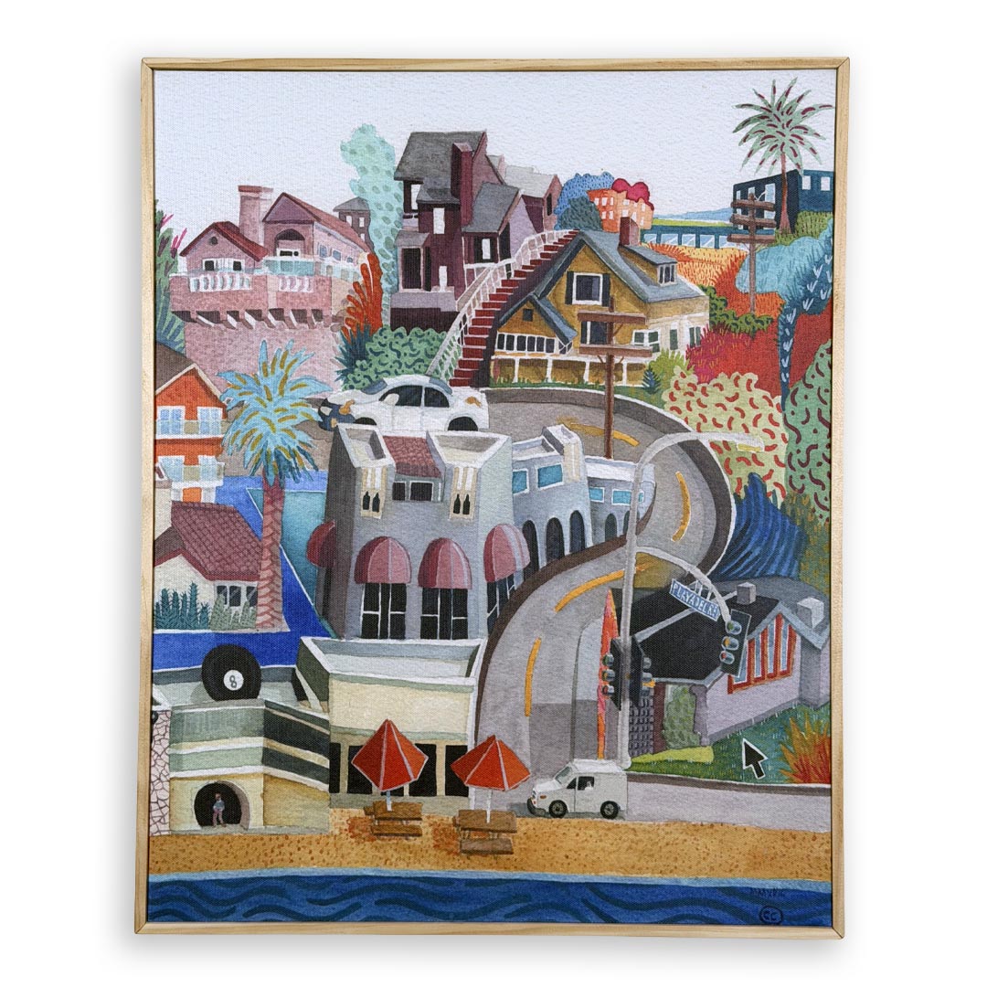 A framed colorful painting depicting a hillside coastal town scene with houses, palm trees, a winding road, beach umbrellas, and ocean water, shown against a plain white background.