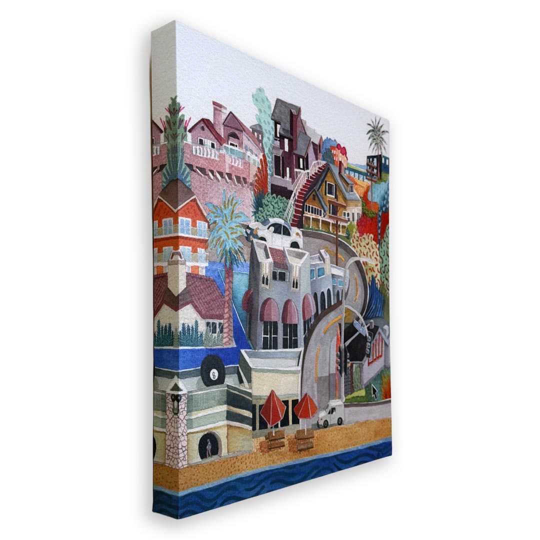 A colorful canvas wall art print depicting a whimsical coastal town scene with houses, palm trees, a lighthouse, beach umbrellas, and water, shown at an angle against a plain white background.